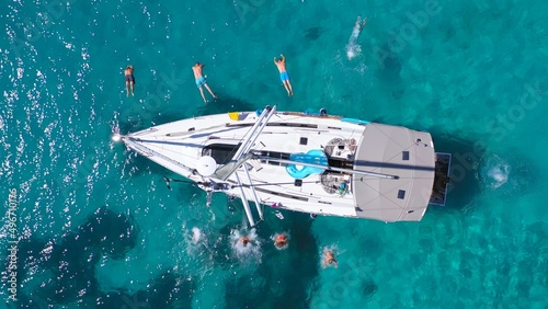 Top view of young friends jumping from sailboat. Yachting. Sail boat party day. Summer luxury boat trip © Big Shot Theory