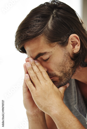 I have no idea how Ill get out of this one. Shot of a young man looking down in distress.