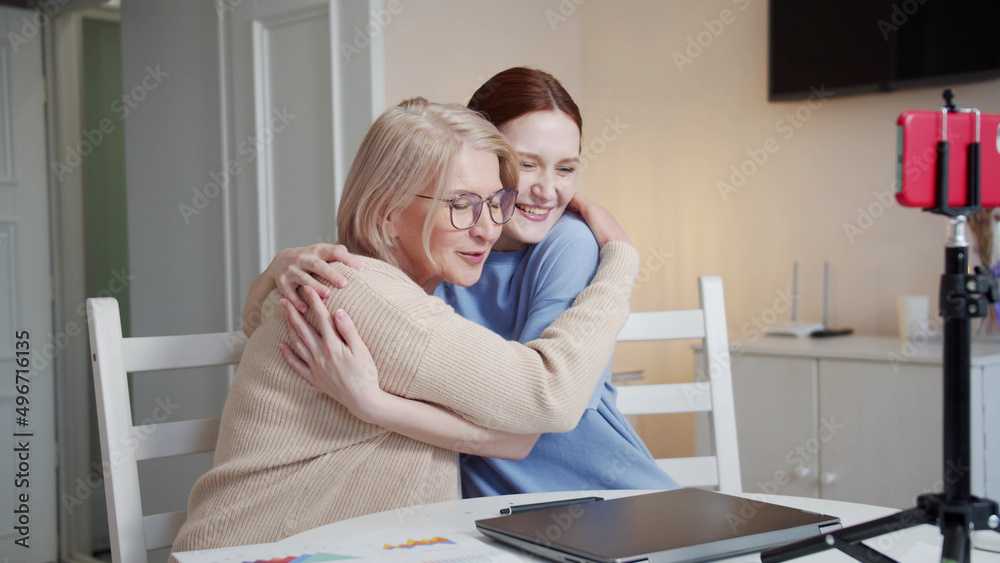 Obraz premium A pensioner and her daughter talk about their startup to investors. They end the video call and give each other high fives