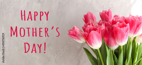 Mother's Day banner. Beautiful pink tulips, and text Happy Mother's Day. Greeting card for a holiday