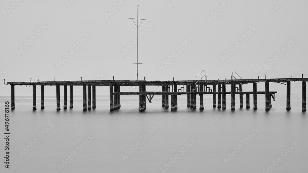 old pier on the beach and long exposure sea waves