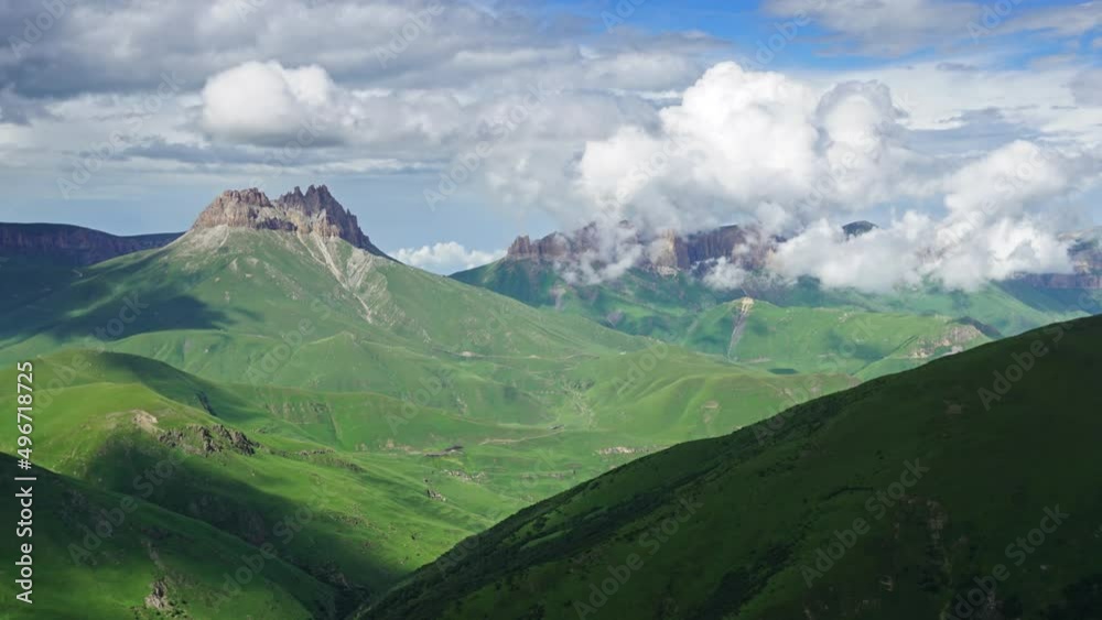 Beautiful summer landscape with fast moving clouds in Caucasus Mountains, Russia, zoom out timelapse 4k