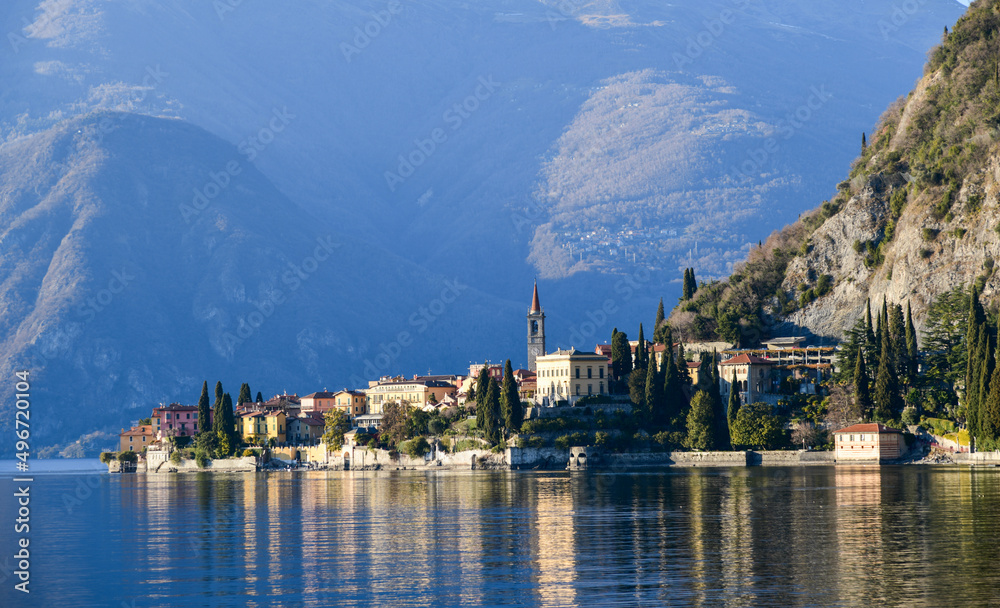 Beautiful view to small town on the shore of Lake Como in Italy. Silhouette of Alp Mountains on the background.