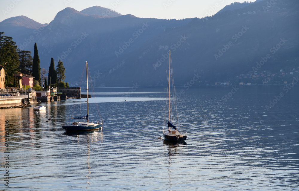 Boats on Lake Como, Alp Mountains around. Romantic getaway.