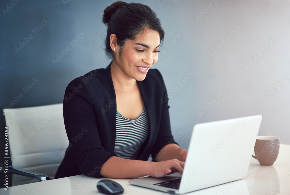 Hard work leads to success. Cropped shot of an attractive young businesswoman working on a laptop in her office. Hard work leads to success. Cropped shot of an attractive young businesswoman working on a laptop in her office.