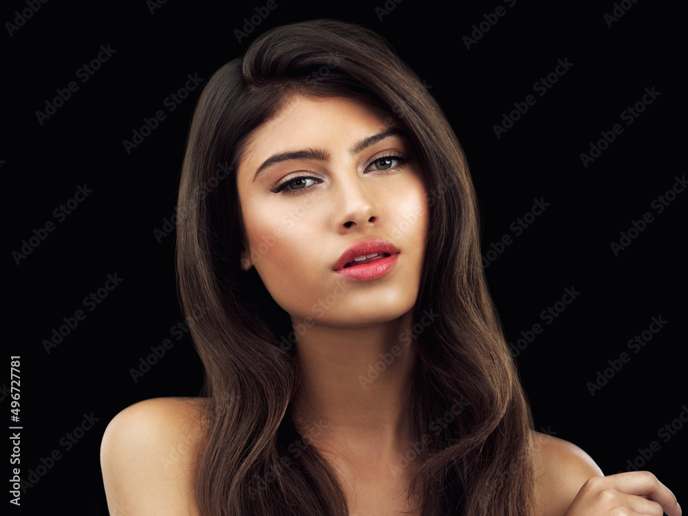 She is the definition of perfection. Studio shot of a beautiful woman posing against a black background. She is the definition of perfection. Studio shot of a beautiful woman posing against a black background.
