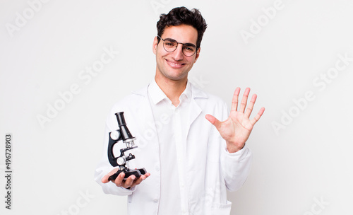 Quadro su tela handsome hispanic man smiling and looking friendly, showing number five