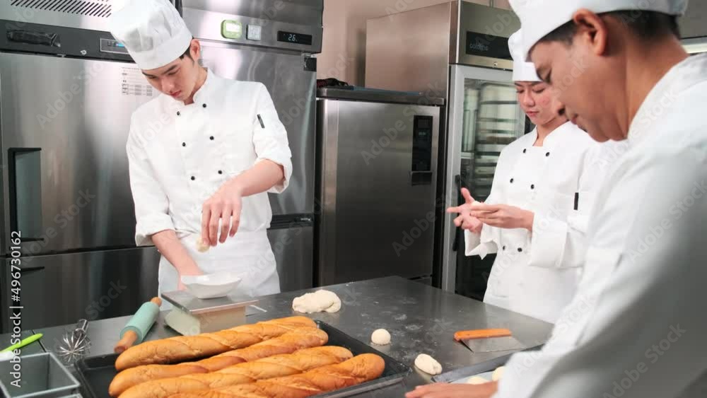 Multiracial professional gourmet team, four chefs in white cook ...