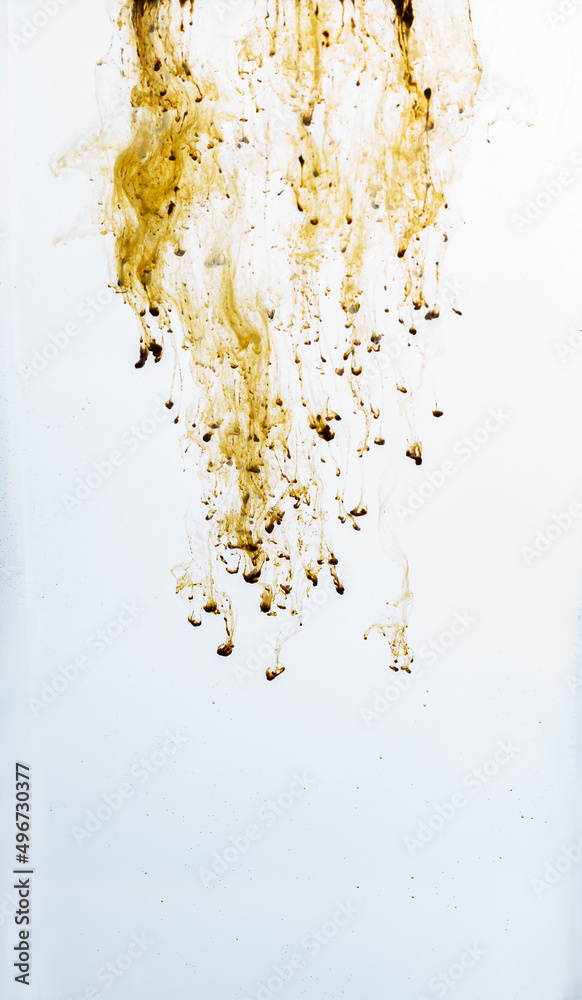 vertical. dissolution of Instant coffee, brown on white with copy space. Abstract background. vertical. dissolution of Instant coffee, brown on white with copy space. Abstract background.