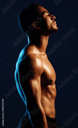 Strengthen your mind, strengthen your body. Studio shot of a fit young man posing against a black background.