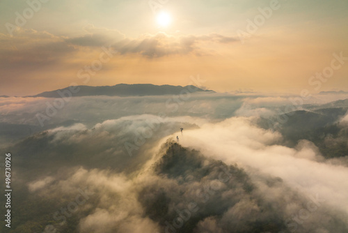 Aerial view fog in the forest and mountains and the transmission towers. Repeater station.