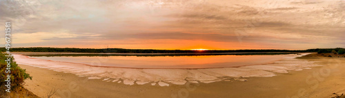Sunrise and its kaleidoscope of colours over a dry salt lake in the Australian outback. © wrightouthere