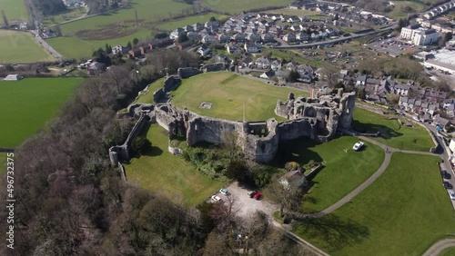 An aerial view of Denbigh Castle ruins on a sunny day, flying right to left around the castle, Denbighshire, North Wales, UK photo
