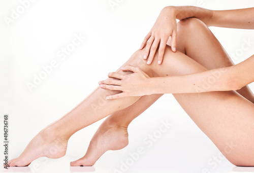 You cant help but touch it. Cropped shot of an unrecognizable womans legs in studio against a grey background.