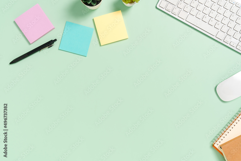 Minimal work space - Creative flat lay photo of workspace desk. Top view office desk with keyboard, mouse and book on pastel green color background. Top view with copy space, flat lay photography. Minimal work space - Creative flat lay photo of workspace desk. Top view office desk with keyboard, mouse and book on pastel green color background. Top view with copy space, flat lay photography.