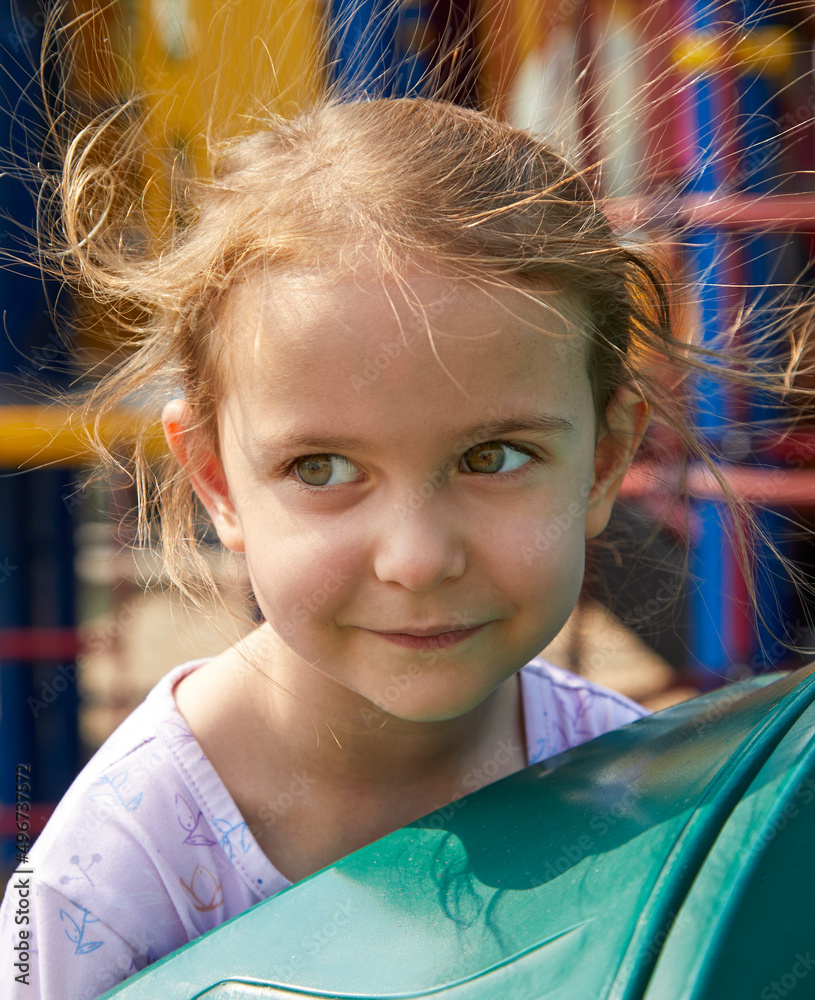 Hair standing up straight on the head of a cute little girl with static