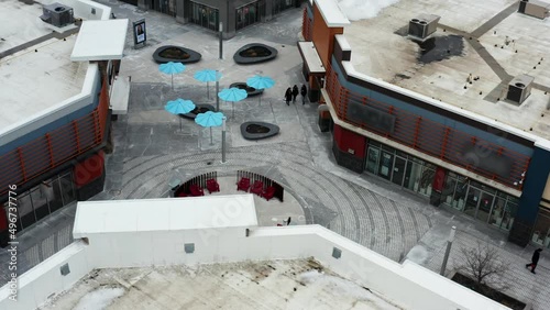 Shoppers walking through outdoor mall in winter in Canada by fire