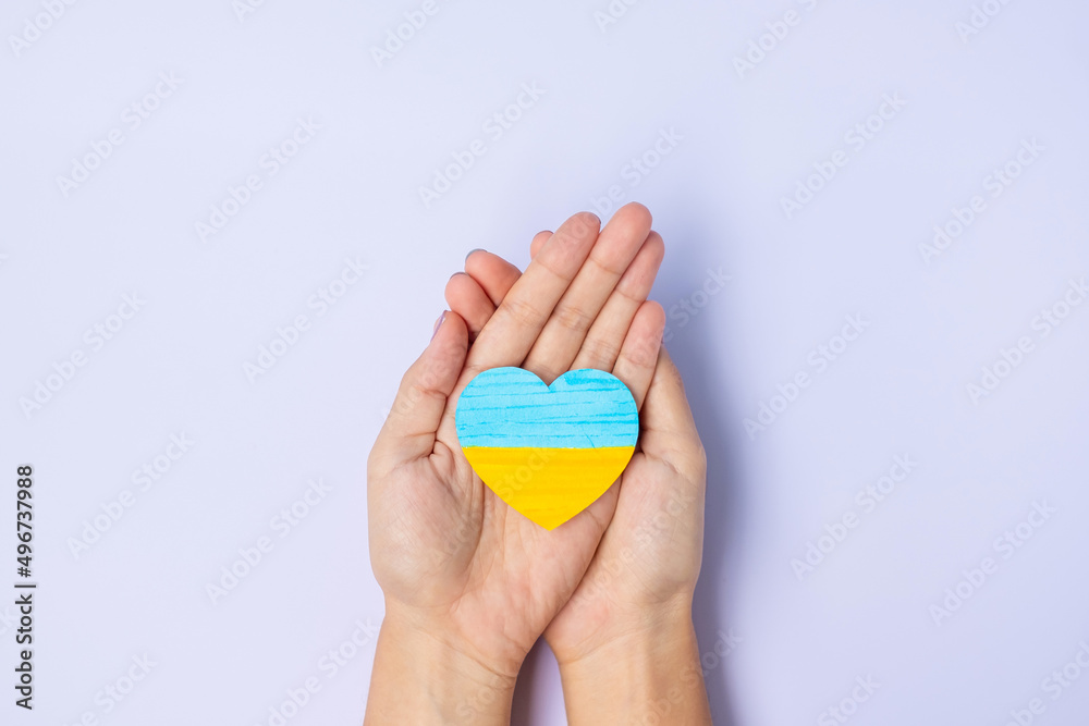 Support for Ukraine in the war with Russia, Hands holding symbol of Heart with flag of Ukraine. Pray, No war, stop war and stand with Ukraine Support for Ukraine in the war with Russia, Hands holding symbol of Heart with flag of Ukraine. Pray, No war, stop war and stand with Ukraine