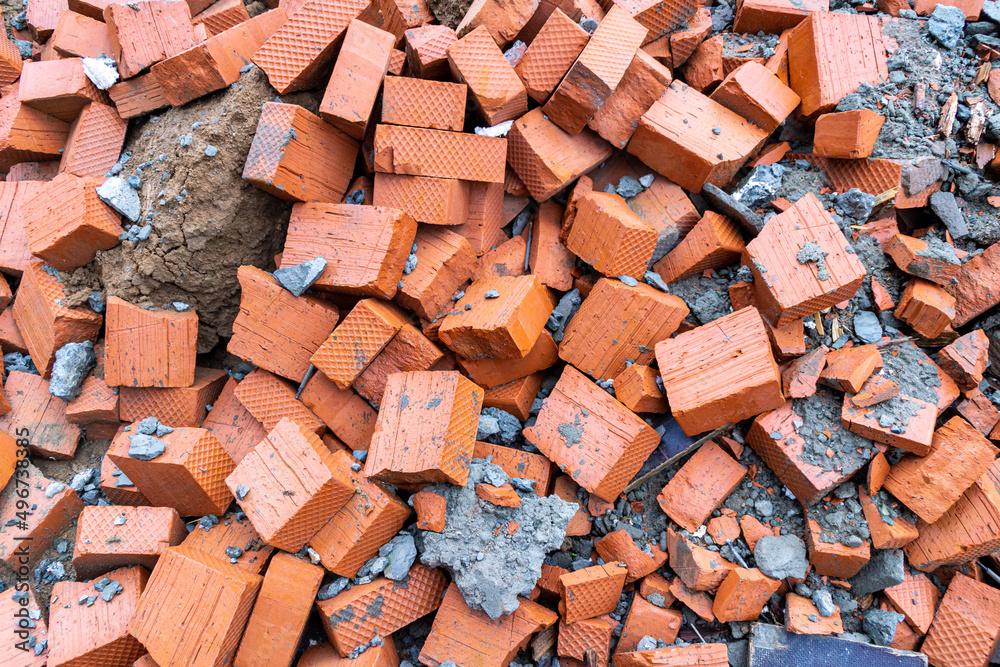 brick fight - halves of new bricks are piled up mixed with other construction debris brick fight - halves of new bricks are piled up mixed with other construction debris