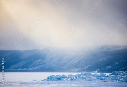 Canvas Print Winter colourful fog over frozen lake Baikal and ice hummocks with mountainous b