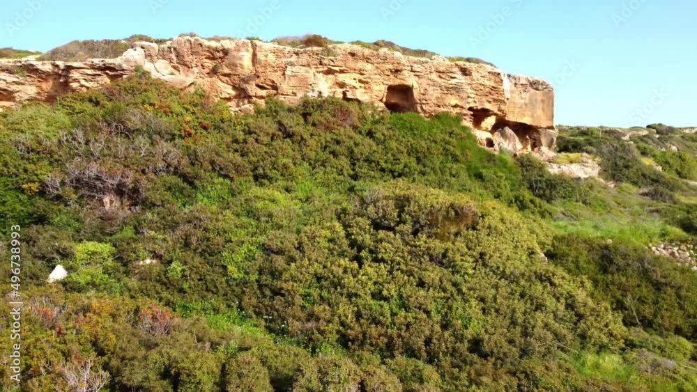 Caves in the mountains on the Mediterranean coast in Cyprus. Drone aerial video.