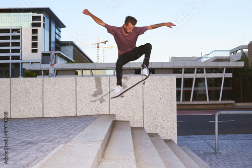In skateboarding theres no such thing as limits. Shot of a young man skating down a flight of stairs. photo