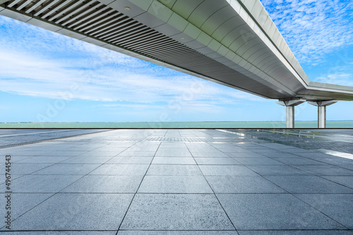 Empty square floor and bridge with river under blue sky © ABCDstock