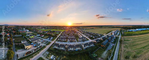 Aerial view of suburban neighborhood, Residential district with buildings and streets at small european town at sunset, panorama