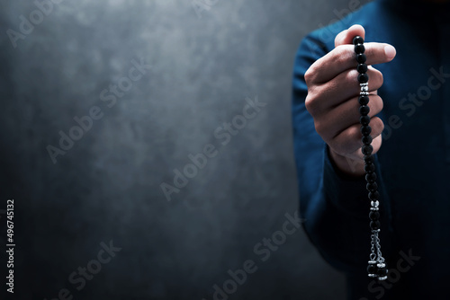 Muslim man praying with rosary beads photo