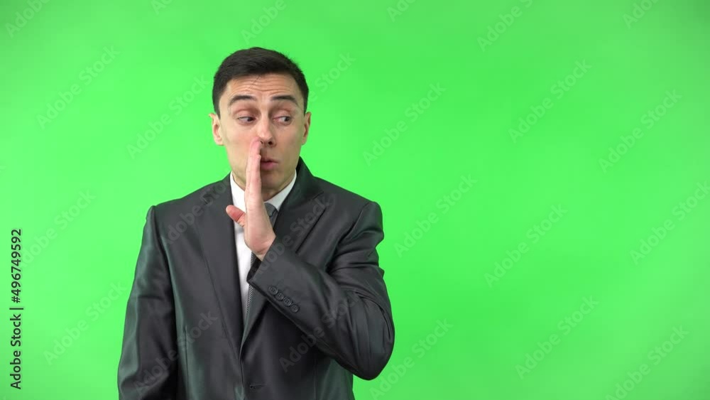 Confident handsome male showing gesture of whispering secret Confident handsome male showing gesture of whispering secret