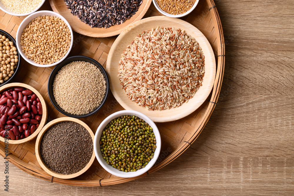 Various cereal, grain, bean, legume and seed in bowl on wooden background, Food ingredients, Table top view