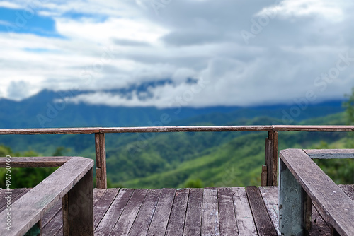 Close-up empty old wooden terrace from highland for use viewpoint with outdoor theme on blurred cloud and high mountain background