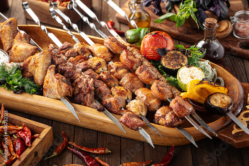 Assorted grilled caucasian shashlik kebabs on the wooden board