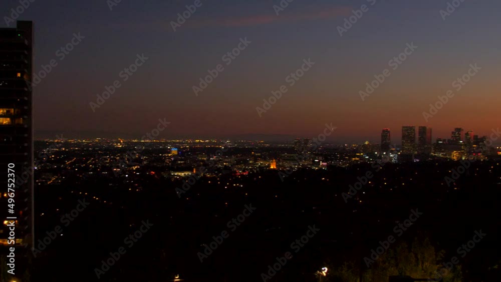 View left to right of Downtown Los Angeles Skyline in USA at dawn. Beautiful colorful sky over the city, sunset fading to night. View left to right of Downtown Los Angeles Skyline in USA at dawn. Beautiful colorful sky over the city, sunset fading to night.