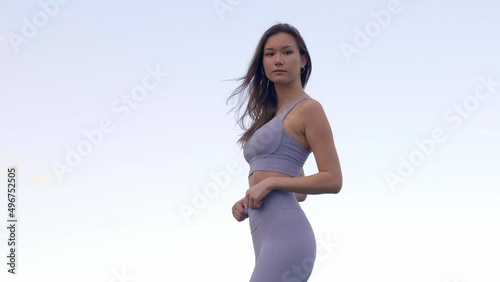 Side view, stunning mixed race Asian woman modeling athleisure wear, Slow Motion photo