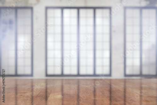 wooden table in the room with big windows