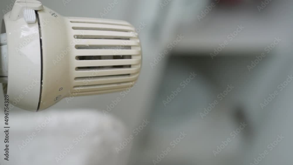 Setting Low the Radiator Temperature, Changing Thermostat Value, and Checking Thermic Energy Consumption. Energy Crisis Concept. Setting Low the Radiator Temperature, Changing Thermostat Value, and Checking Thermic Energy Consumption. Energy Crisis Concept.
