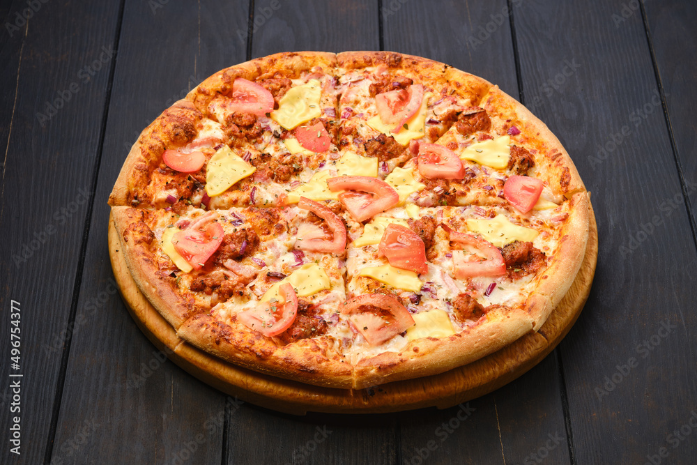 Pizza with minced meat, cheddar and tomato