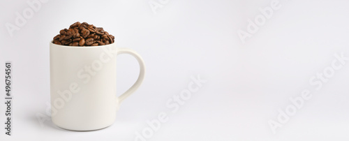 One white coffee mug, fresh roasted coffee beans, light background, place for text