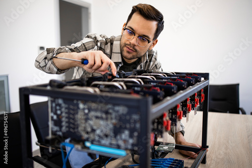 An expert or engineer setting up bitcoin rig for mining cryptocurrency.