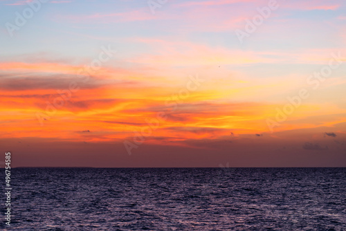 Beautiful view of the sea and the sky in the clouds at sunset. Orange red dawn, dusk on the sea coast © Yarkovoy