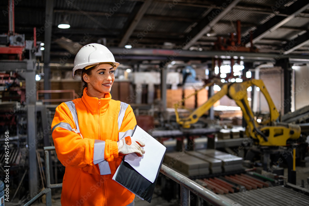 Portrait of female supervisor checking production line in manufacturing factory. Portrait of female supervisor checking production line in manufacturing factory.