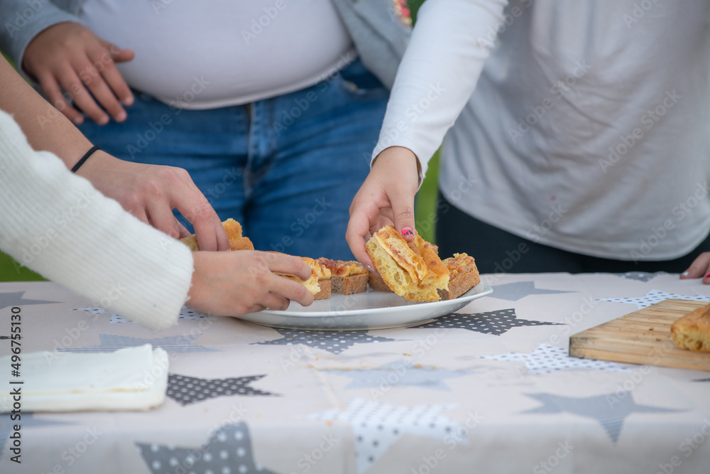 Children eating fig jam on slices of bread outdoor. Children eating fig jam on slices of bread outdoor.