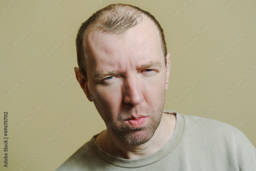 The man looks in disbelief. Portrait of a young man making faces The man looks in disbelief. Portrait of a young man making faces
