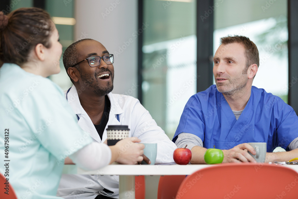 Fototapeta premium doctors and nurses in hospital rest room taking a break
