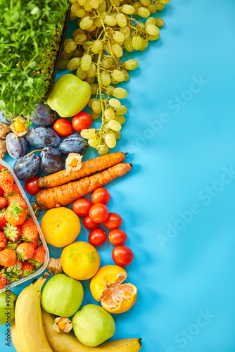 Flat lay of ripe organic healthy food Fruits, microgreens, vegetables on blue  background, copy space for text, top view, market local farm concept, harvest, food delivary, diet, vegan concept.