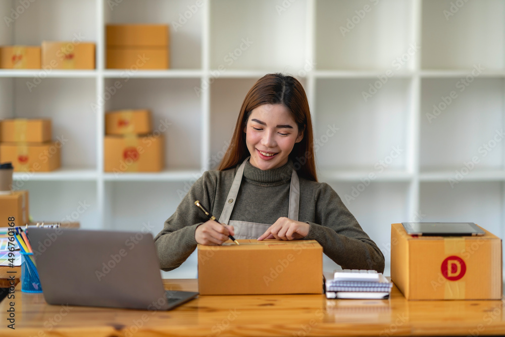 Asian Small business entrepreneur SME working with box at home, SME e-commerce digital technology concept. Asian Small business entrepreneur SME working with box at home, SME e-commerce digital technology concept.