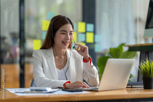 Attractive asian woman using laptop while doing homework making video call abroad using internet friend connection, business women use computer analysis finance data