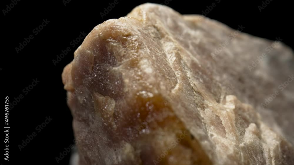 Solid piece of granite or quartz stone against black background. Natural rough mineral. Background of natural structure of stone. Concept of geology, ore mining, building material. Macro close up. Solid piece of granite or quartz stone against black background. Natural rough mineral. Background of natural structure of stone. Concept of geology, ore mining, building material. Macro close up.