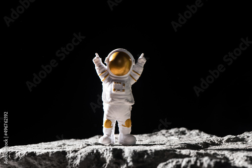 Fototapeta Naklejka Na Ścianę i Meble -  Spaceman on surface of rocks.  Astronaut in deep black space.